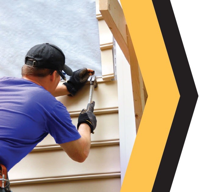 Exteriors professional working on siding